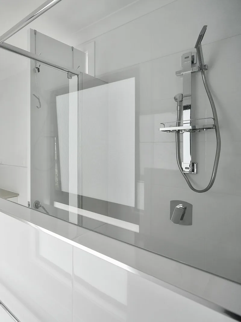 Clear glass shower panel with chrome shower fixtures, a shower glass service we offer in Brock Township